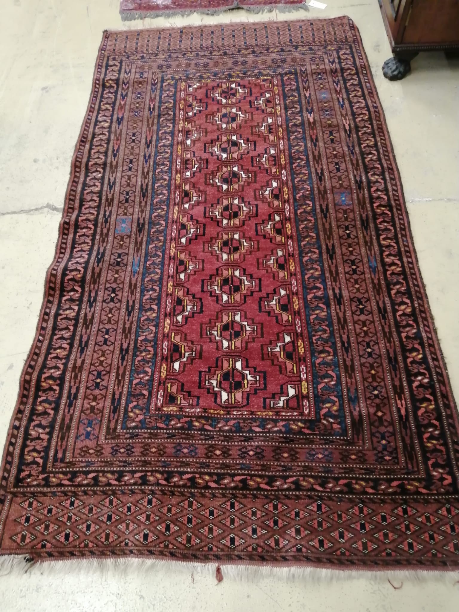 A Belouch red ground rug, 195 x 106cm